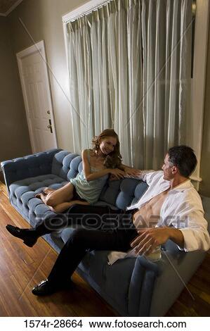 Picture - Mid adult man looking at a young prostitute. Fotosearch