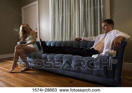 Stock Image - Mid adult man looking at a young prostitute. Fotosearch