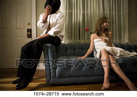 Mid adult man sitting by a young prostitute on sofa View Large Photo Image Stock Photography - Mid adult man sitting by a young prostitute on sofa. Fotosearch