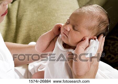 Mid adult woman holding her baby in hands View Large Photo Image Picture - Mid adult woman holding her baby in hands. Fotosearch