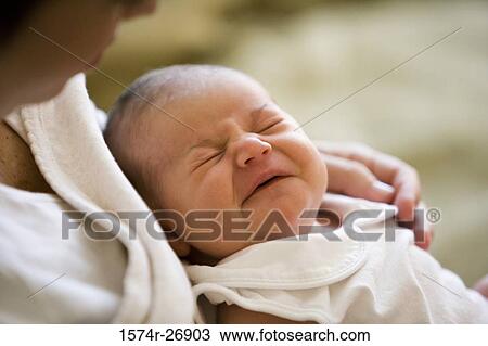 Mid adult woman holding her baby in hands View Large Photo Image Stock Image - Mid adult woman holding her baby in hands. Fotosearch