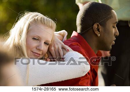 Mid adult woman leaning on young man and looking away View Large Photo Image Stock Photography - Mid adult woman leaning on young man and looking away. Fotosearch