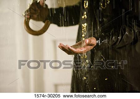 Midsection of a man standing in the rain View Large Photo Image Stock Photography - Midsection of a man standing in the rain. Fotosearch