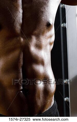Midsection of a shirtless man after working out in the gym View Large Photo Image Stock Photography - Midsection of a shirtless man after working out in the gym. Fotosearch