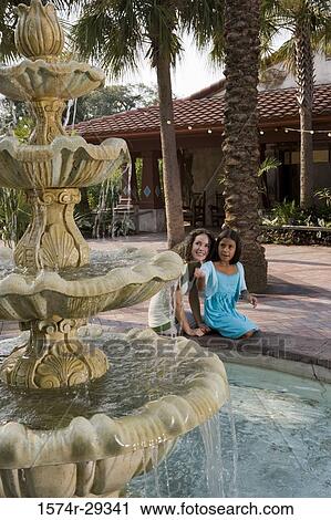 Mother and daughter looking at water fountain and smiling View Large Photo Image Stock Image - Mother and daughter looking at water fountain and smiling. Fotosearch