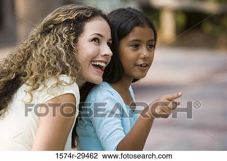 Stock Image - Mother and daughter sitting together. Fotosearch