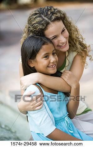 Stock Photo - Mother and daughter sitting together. Fotosearch