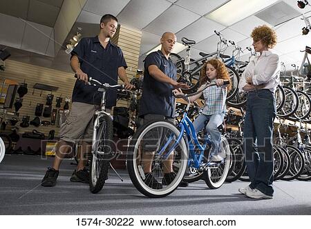 Mother and daughter with men in a bicycle shop View Large Photo Image Stock Image - Mother and daughter with men in a bicycle shop. Fotosearch