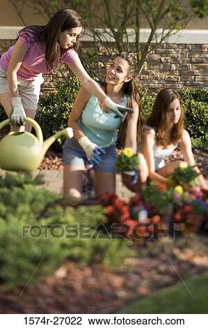 Mother and daughters gardening View Large Photo Image Stock Image - Mother and daughters gardening. Fotosearch