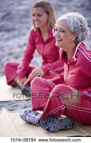 Mother exercising with her daughter at the beach View Large Photo Image Picture - Mother exercising with her daughter at the beach. Fotosearch