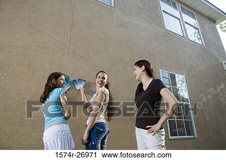mother with her daughters holding color swatches against wall View Large Photo Image Stock Image - mother with her daughters holding color swatches against wall. Fotosearch