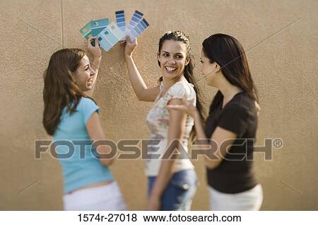 mother with her daughters holding color swatches against wall View Large Photo Image Stock Photo - mother with her daughters holding color swatches against wall. Fotosearch