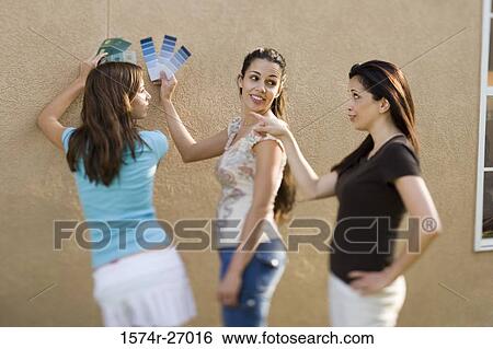 mother with her daughters holding color swatches against wall View Large Photo Image Stock Photograph - mother with her daughters holding color swatches against wall. Fotosearch