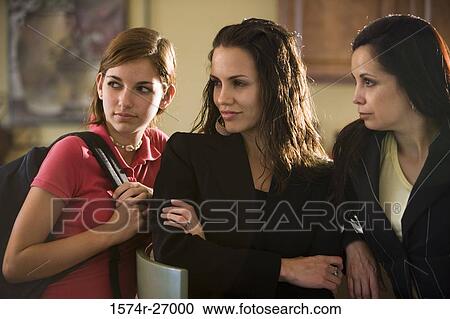Stock Image - Mother with her daughters looking to side. Fotosearch