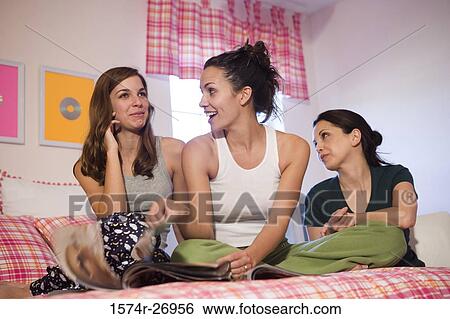 Mother with her daughters smiling in bedroom View Large Photo Image Stock Photograph - Mother with her daughters smiling in bedroom. Fotosearch