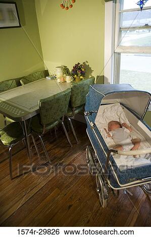 Stock Photograph - Newborn baby sleeping in baby carriage. Fotosearch