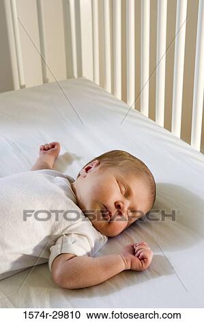 Newborn baby sleeping on the bed View Large Photo Image Stock Image - Newborn baby sleeping on the bed. Fotosearch