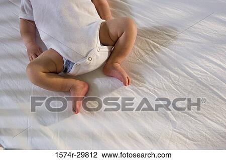 Newborn baby sleeping on the bed View Large Photo Image Stock Image - Newborn baby sleeping on the bed. Fotosearch