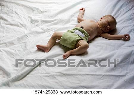 Newborn baby sleeping on the bed View Large Photo Image Stock Image - Newborn baby sleeping on the bed. Fotosearch