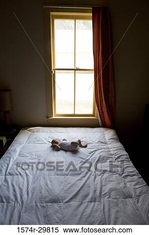 Newborn baby sleeping on the bed View Large Photo Image Stock Photography - Newborn baby sleeping on the bed. Fotosearch