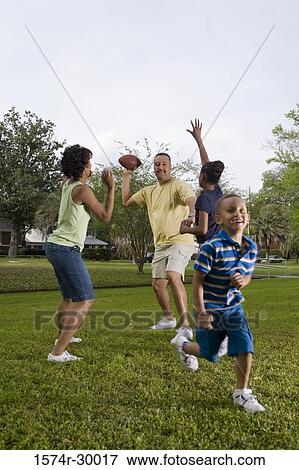 Parents playing with their children at park View Large Photo Image Stock Photo - Parents playing with their children at park. Fotosearch