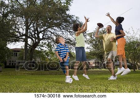 Parents playing with their children at park View Large Photo Image Stock Photo - Parents playing with their children at park. Fotosearch