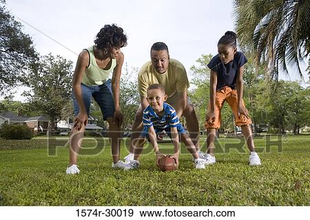 Parents playing with their children at park View Large Photo Image Stock Photo - Parents playing with their children at park. Fotosearch