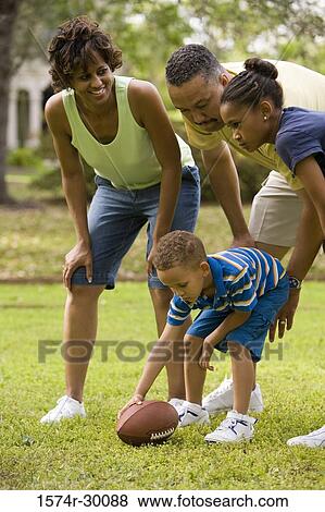 Parents playing with their children at park View Large Photo Image Stock Photo - Parents playing with their children at park. Fotosearch