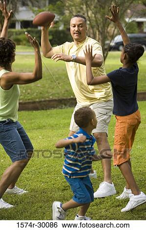 Parents playing with their children at park View Large Photo Image Stock Photograph - Parents playing with their children at park. Fotosearch