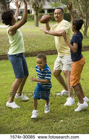 Stock Photography - Parents playing with their children at park. Fotosearch