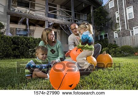 Parents playing with their children in front of a house View Large Photo Image Stock Image - Parents playing with their children in front of a house. Fotosearch