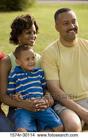Parents sitting with their son on the bench at park View Large Photo Image Picture - Parents sitting with their son on the bench at park. Fotosearch