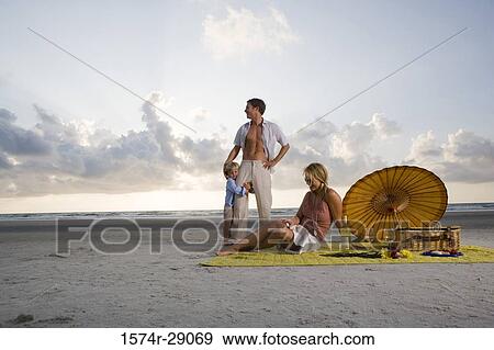 Parents with their son at the beach View Large Photo Image Stock Photo - Parents with their son at the beach. Fotosearch