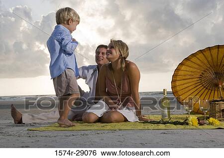Parents with their son at the beach View Large Photo Image Stock Photograph - Parents with their son at the beach. Fotosearch