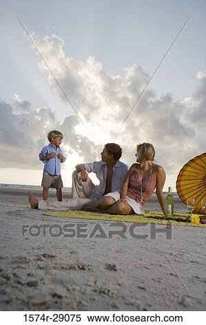 Stock Photography - Parents with their son at the beach. Fotosearch