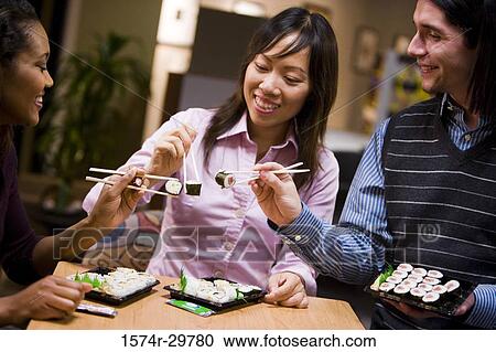 People sitting and eating food View Large Photo Image Stock Image - People sitting and eating food. Fotosearch