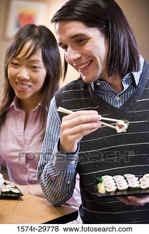 People sitting and eating food View Large Photo Image Stock Photo - People sitting and eating food. Fotosearch