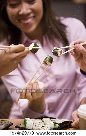 People sitting and eating food View Large Photo Image Stock Photo - People sitting and eating food. Fotosearch