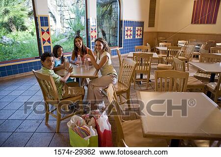 People sitting together on chairs by table in hotel View Large Photo Image Stock Image - People sitting together on chairs by table in hotel. Fotosearch
