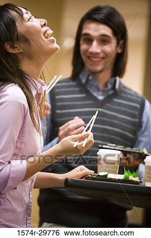 People standing and eating food View Large Photo Image Stock Photograph - People standing and eating food. Fotosearch