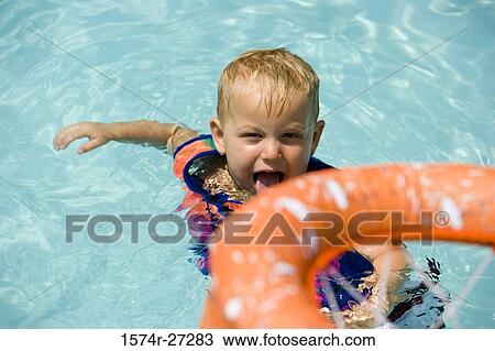 Portrait of a boy making a face and sticking out tongue in swimming pool View Large Photo Image Stock Image - Portrait of a boy making a face and sticking out tongue in swimming pool. Fotosearch