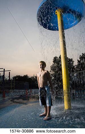 Portrait of a boy standing under a shower View Large Photo Image Stock Photograph - Portrait of a boy standing under a shower. Fotosearch