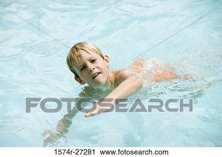 Portrait of a boy swimming in swimming pool View Large Photo Image Stock Image - Portrait of a boy swimming in swimming pool. Fotosearch