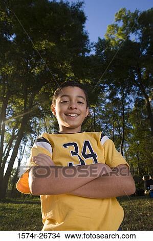 Portrait of a boy with arms crossed smiling at forest View Large Photo Image Picture - Portrait of a boy with arms crossed smiling at forest. Fotosearch