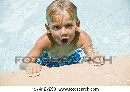 Portrait of a boy with mouth open in swimming pool View Large Photo Image Stock Photo - Portrait of a boy with mouth open in swimming pool. Fotosearch