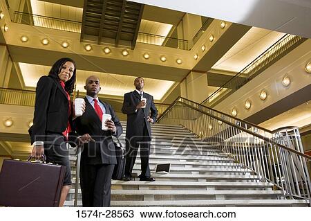 Portrait of a business people standing on staircase at office View Large Photo Image Stock Image - Portrait of a business people standing on staircase at office. Fotosearch