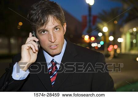Portrait of a businessman communicating on cellphone View Large Photo Image Stock Photo - Portrait of a businessman communicating on cellphone. Fotosearch
