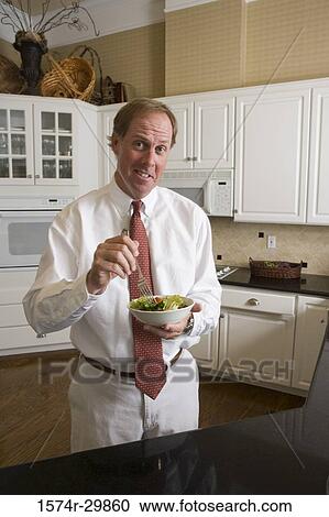 Portrait of a businessman holding salad in a bowl View Large Photo Image Stock Image - Portrait of a businessman holding salad in a bowl. Fotosearch
