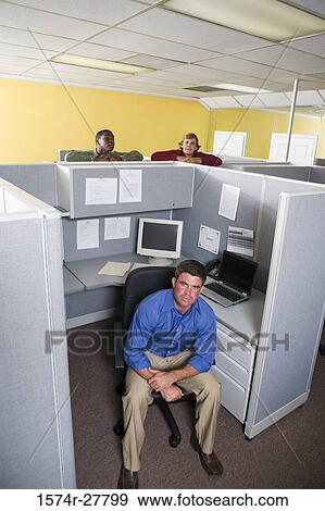 Portrait of a businessman sitting on a chair while other in the background View Large Photo Image Stock Photo - Portrait of a businessman sitting on a chair while other in the background. Fotosearch