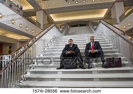 Portrait of a businessmen sitting on staircase View Large Photo Image Stock Photograph - Portrait of a businessmen sitting on staircase. Fotosearch